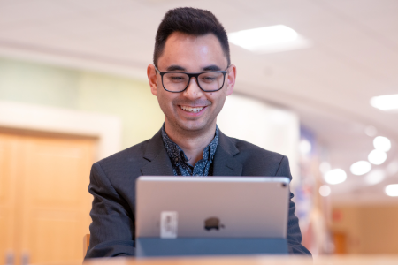 Smiling man looking at laptop