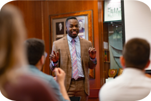 Man talking in front of a crowd